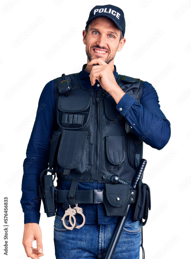 Young handsome man wearing police uniform looking confident at the camera smiling with crossed arms and hand raised on chin. thinking positive. Young handsome man wearing police uniform looking confident at the camera smiling with crossed arms and hand raised on chin. thinking positive.