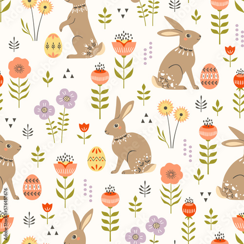 Easter seamless pattern with cute decorative bunnies, Easter eggs and spring flowers in modern folk style. Great for Easter wrapping paper, wallpaper, textile, packaging. Warm pastel colours.