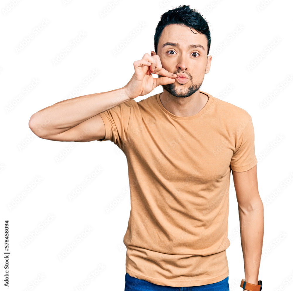 Hispanic man with beard wearing casual t shirt mouth and lips shut as zip with fingers. secret and silent, taboo talking Hispanic man with beard wearing casual t shirt mouth and lips shut as zip with fingers. secret and silent, taboo talking