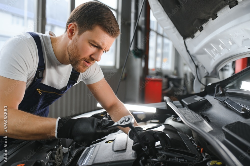 Auto mechanic working on car engine in mechanics garage. Repair service. Auto mechanic working on car engine in mechanics garage. Repair service.