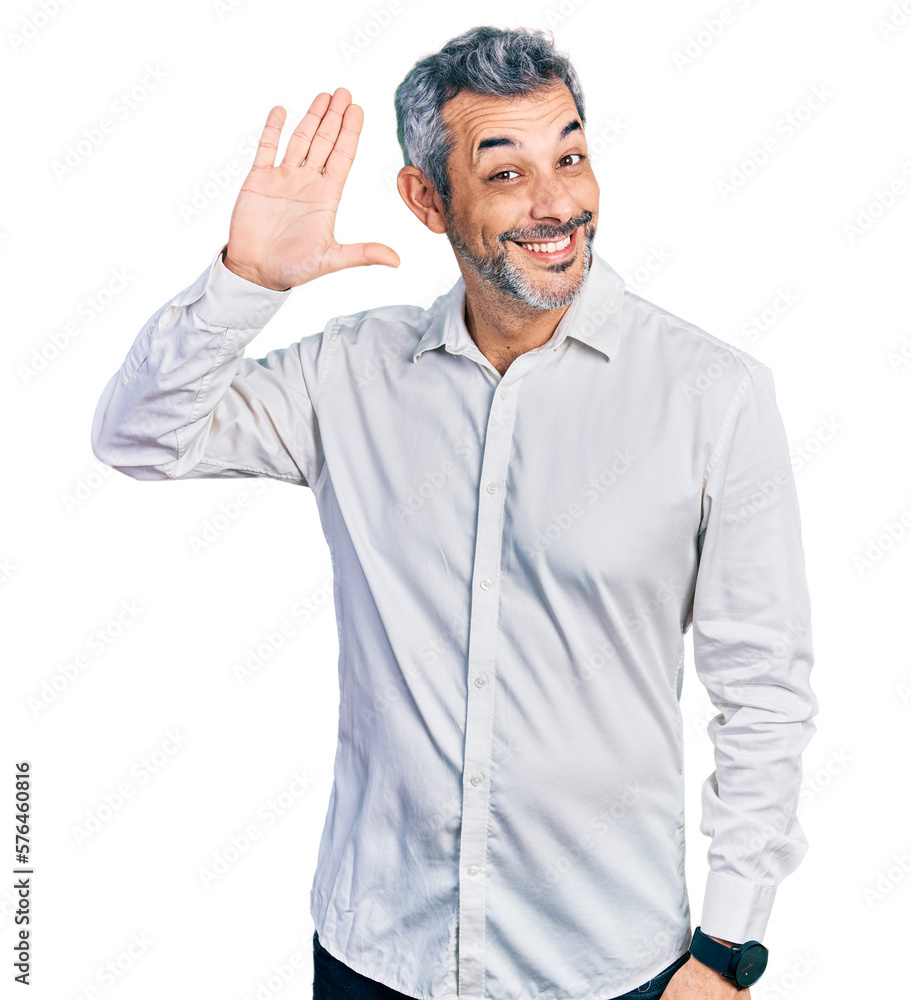 Middle age hispanic with grey hair wearing casual white shirt waiving saying hello happy and smiling, friendly welcome gesture Middle age hispanic with grey hair wearing casual white shirt waiving saying hello happy and smiling, friendly welcome gesture