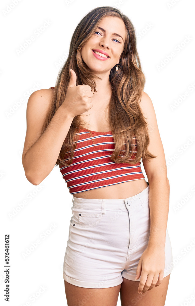 Beautiful caucasian young woman wearing casual clothes doing happy thumbs up gesture with hand. approving expression looking at the camera showing success. Beautiful caucasian young woman wearing casual clothes doing happy thumbs up gesture with hand. approving expression looking at the camera showing success.