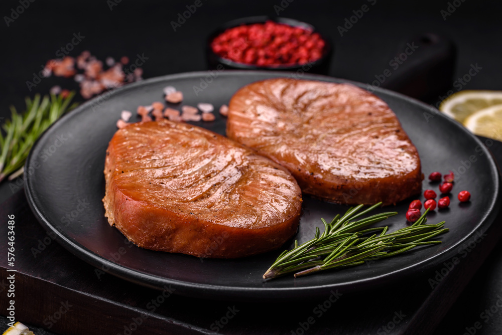 Two baked slices of tuna fillet with spices and herbs Two baked slices of tuna fillet with spices and herbs