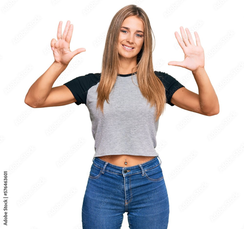 Young blonde woman wearing casual clothes showing and pointing up with fingers number nine while smiling confident and happy. Young blonde woman wearing casual clothes showing and pointing up with fingers number nine while smiling confident and happy.