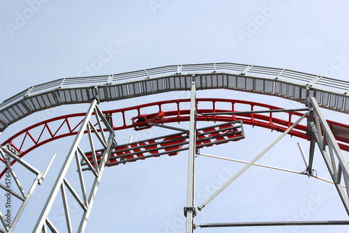 Fototapeta Naklejka Na Ścianę i Meble -  Metal roller coaster close up with red rails
