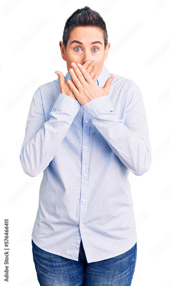 Young woman with short hair wearing business clothes shocked covering mouth with hands for mistake. secret concept. Young woman with short hair wearing business clothes shocked covering mouth with hands for mistake. secret concept.