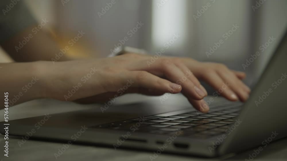 Woman hands coding on laptop, female arms typing close up Woman hands coding on laptop, female arms typing close up