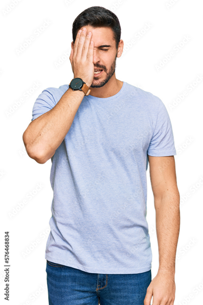 Young hispanic man wearing casual clothes yawning tired covering half face, eye and mouth with hand. face hurts in pain. Young hispanic man wearing casual clothes yawning tired covering half face, eye and mouth with hand. face hurts in pain.