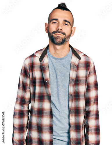 Hispanic man with ponytail wearing casual shirt with serious expression on face. simple and natural looking at the camera.