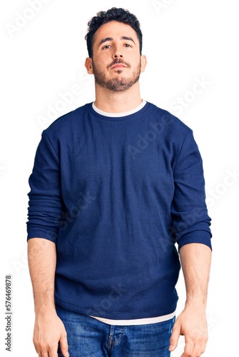 Young hispanic man wearing casual clothes relaxed with serious expression on face. simple and natural looking at the camera.
