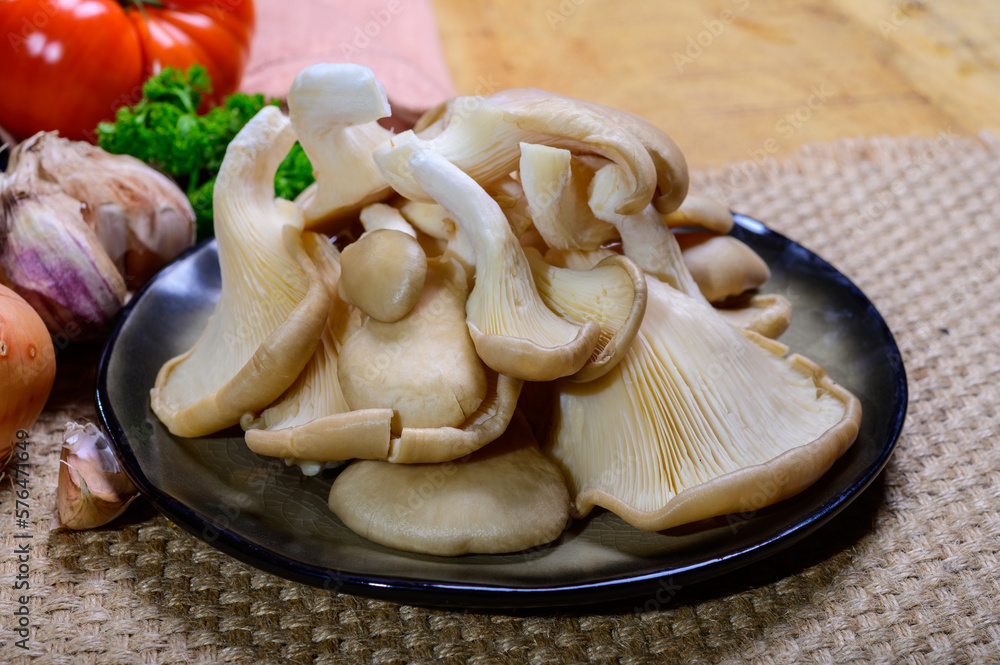 Tasty vegetarian food, fresh organic Pleurotus ostreatus, or oyster mushrooms, hiratake, or pearl oyster mushrooms Tasty vegetarian food, fresh organic Pleurotus ostreatus, or oyster mushrooms, hiratake, or pearl oyster mushrooms