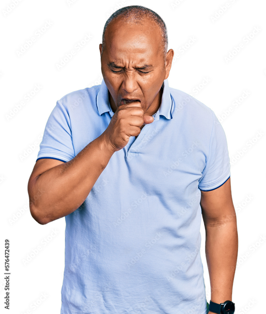 Hispanic middle age man wearing casual t shirt feeling unwell and coughing as symptom for cold or bronchitis. health care concept. Hispanic middle age man wearing casual t shirt feeling unwell and coughing as symptom for cold or bronchitis. health care concept.