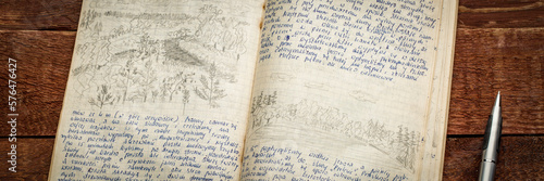 Kayak expedition journal - handwriting in Polish and drawing in pencil against rustic weathered wood.