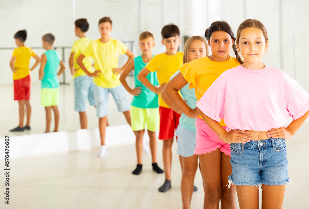 Fototapeta premium Group of kids standing in row during their dance training in studio.