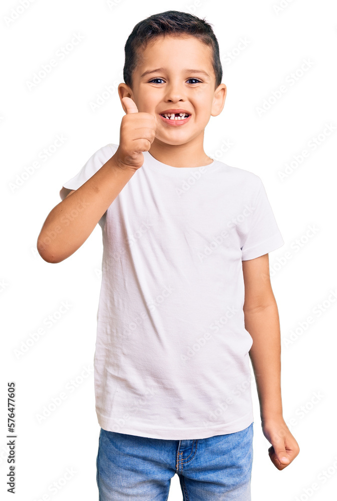 Little cute boy kid wearing casual white tshirt smiling happy and positive, thumb up doing excellent and approval sign Little cute boy kid wearing casual white tshirt smiling happy and positive, thumb up doing excellent and approval sign