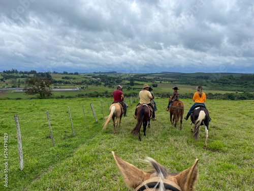 Nellore cattle on a farm in Brazil. People with hats riding horses © Pedro