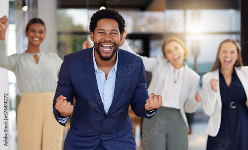 Winning, celebration and excited business black man in office with startup success, happiness and cheering. Collaboration, teamwork and portrait of happy employees with achievement, goals and victory © Joanrae P/peopleimages.com