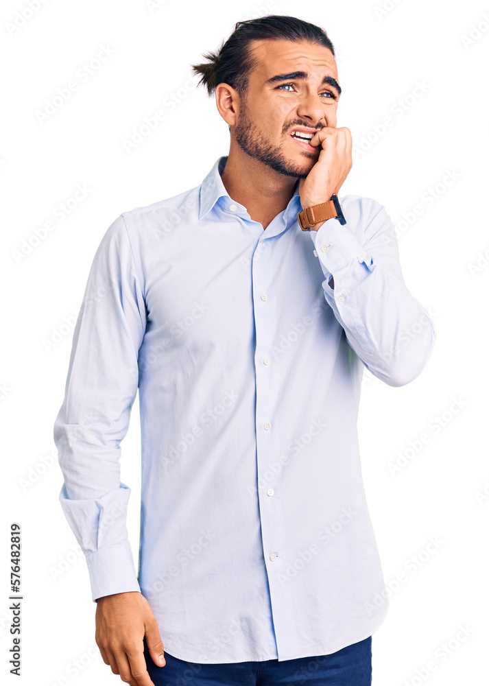 Young handsome man wearing business clothes looking stressed and nervous with hands on mouth biting nails. anxiety problem. Young handsome man wearing business clothes looking stressed and nervous with hands on mouth biting nails. anxiety problem.