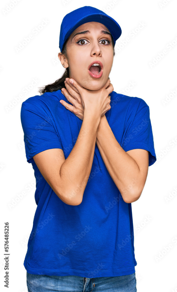 Young hispanic girl wearing delivery courier uniform shouting and suffocate because painful strangle. health problem. asphyxiate and suicide concept. Young hispanic girl wearing delivery courier uniform shouting and suffocate because painful strangle. health problem. asphyxiate and suicide concept.