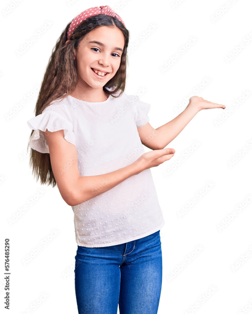 Cute hispanic child girl wearing casual white tshirt inviting to enter smiling natural with open hand Cute hispanic child girl wearing casual white tshirt inviting to enter smiling natural with open hand