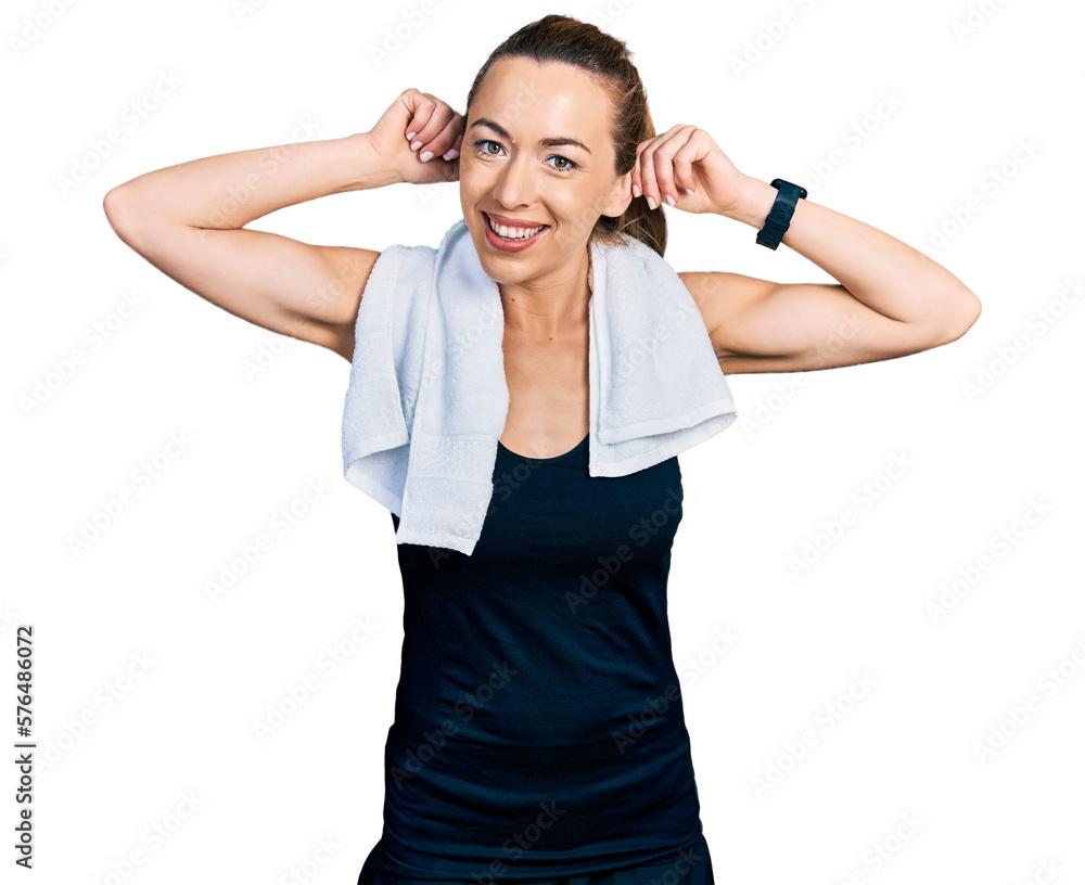 Young caucasian woman wearing sportswear and towel smiling pulling ears with fingers, funny gesture. audition problem Young caucasian woman wearing sportswear and towel smiling pulling ears with fingers, funny gesture. audition problem