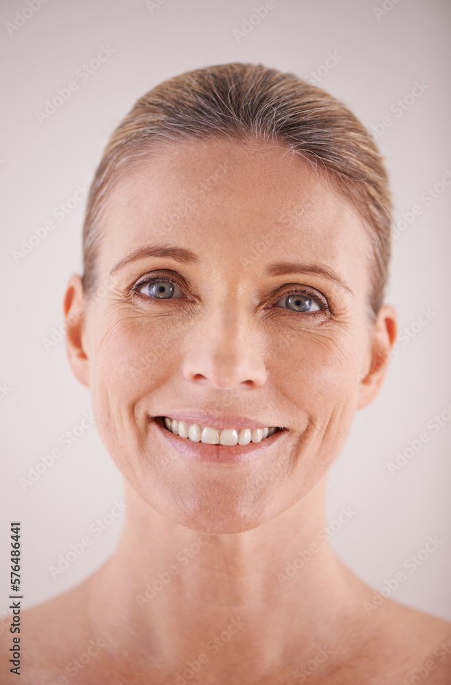 Her beauty shines through. Cropped portrait of a beautiful mature woman posing in studio. Her beauty shines through. Cropped portrait of a beautiful mature woman posing in studio.
