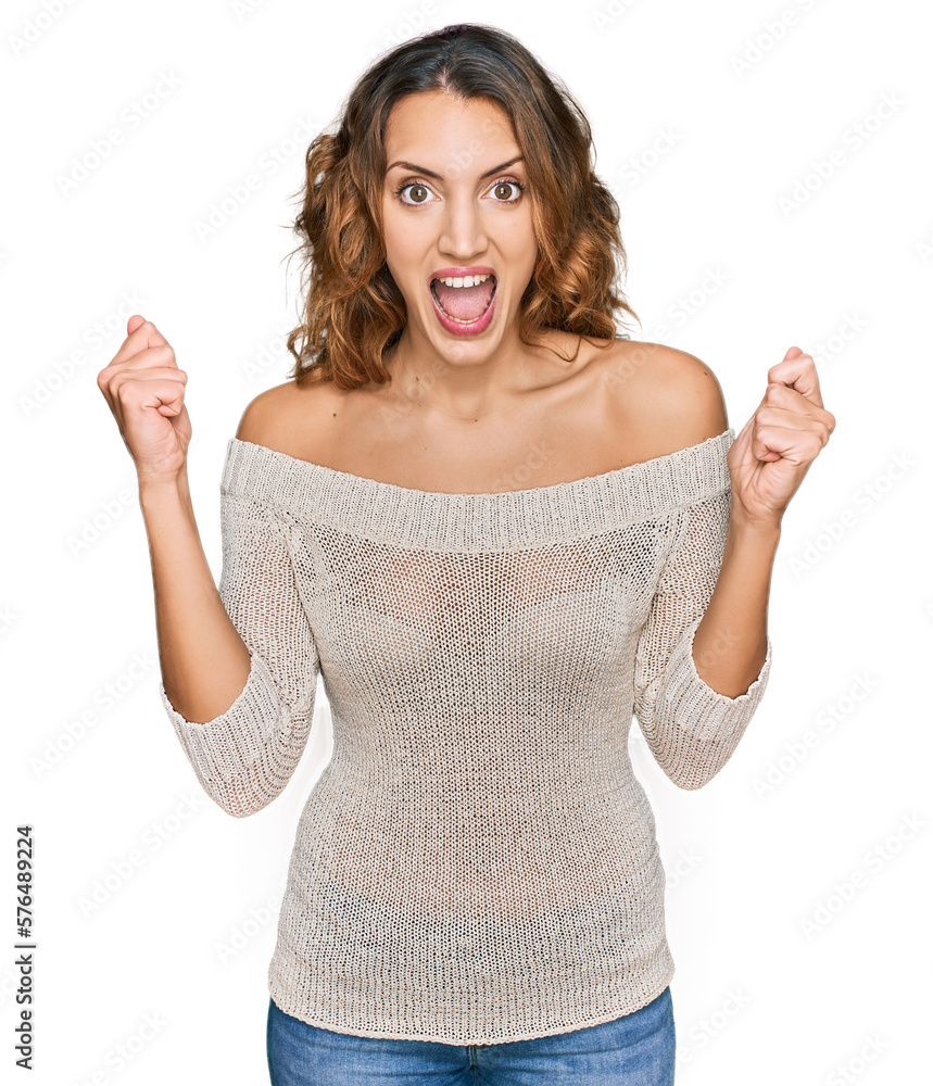 Beautiful young caucasian woman wearing casual clothes celebrating surprised and amazed for success with arms raised and open eyes. winner concept. Beautiful young caucasian woman wearing casual clothes celebrating surprised and amazed for success with arms raised and open eyes. winner concept.