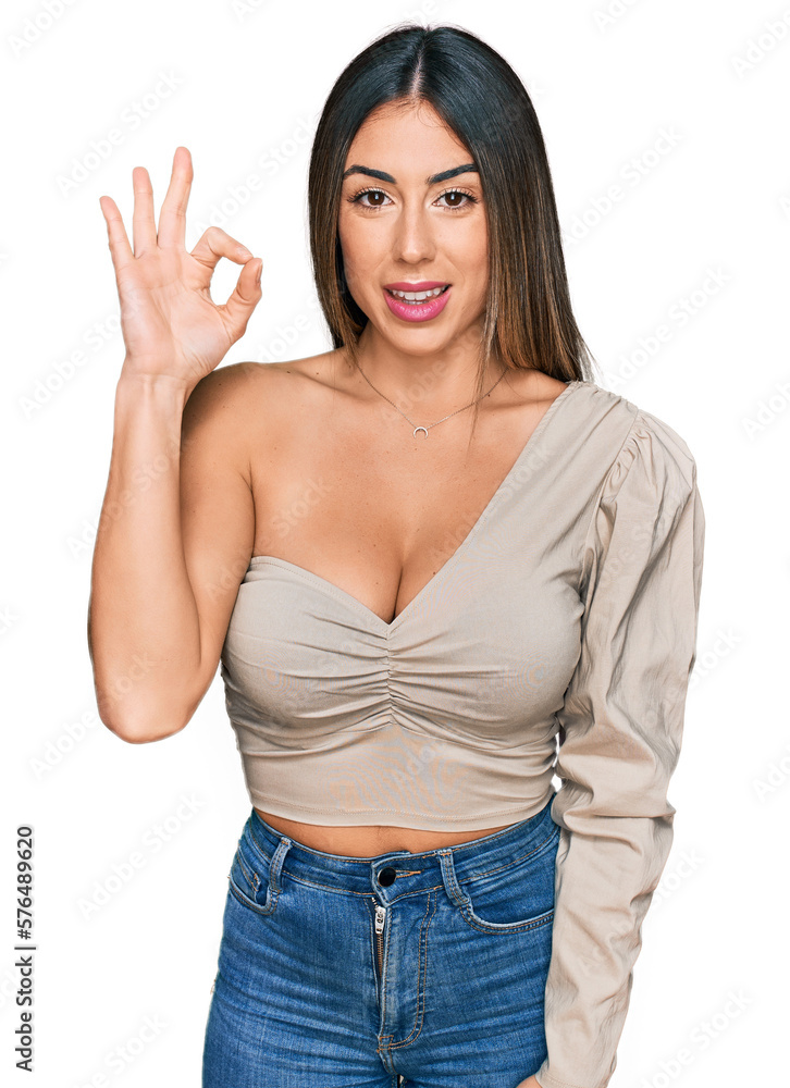 Young hispanic woman wearing casual clothes smiling positive doing ok sign with hand and fingers. successful expression. Young hispanic woman wearing casual clothes smiling positive doing ok sign with hand and fingers. successful expression.