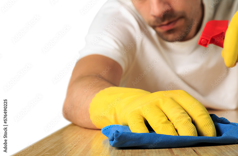 Human in protective gloves is wiping dust using a spray and a duster Human in protective gloves is wiping dust using a spray and a duster