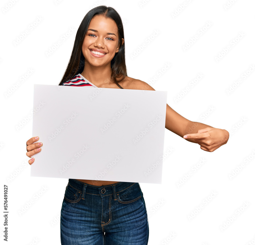 Beautiful hispanic woman holding blank empty banner smiling happy pointing with hand and finger Beautiful hispanic woman holding blank empty banner smiling happy pointing with hand and finger