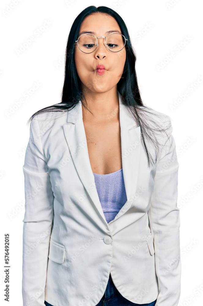 Beautiful hispanic woman with nose piercing wearing business jacket and glasses making fish face with lips, crazy and comical gesture. funny expression. Beautiful hispanic woman with nose piercing wearing business jacket and glasses making fish face with lips, crazy and comical gesture. funny expression.