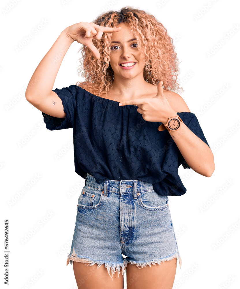 Young blonde woman with curly hair wearing casual summer clothes smiling making frame with hands and fingers with happy face. creativity and photography concept. Young blonde woman with curly hair wearing casual summer clothes smiling making frame with hands and fingers with happy face. creativity and photography concept.