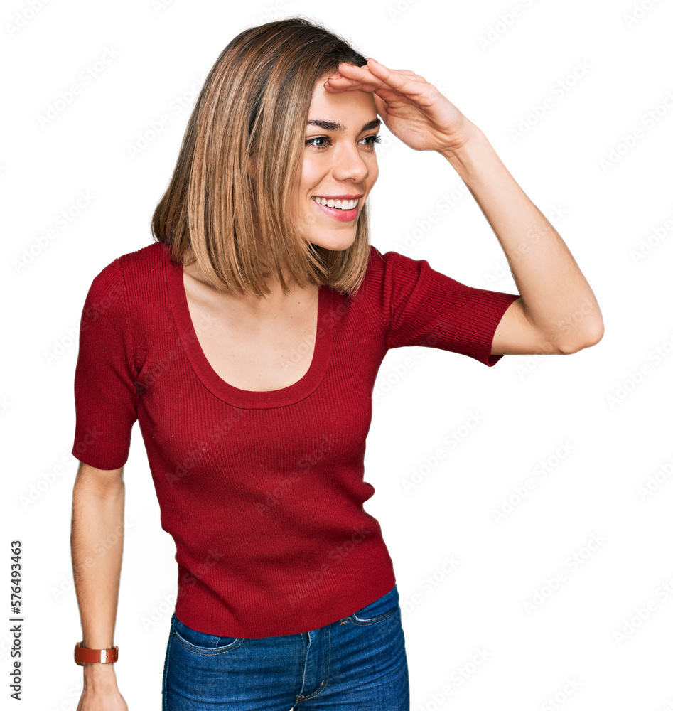 Young blonde girl wearing casual clothes very happy and smiling looking far away with hand over head. searching concept.