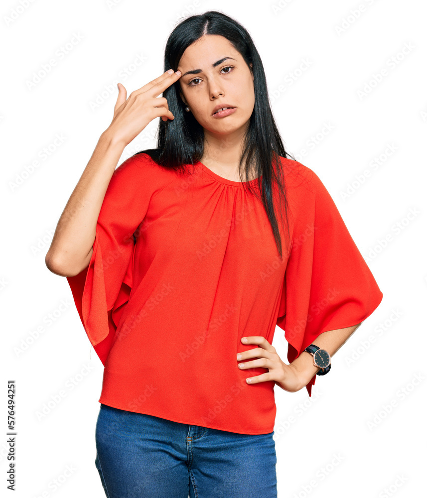 Beautiful young woman wearing casual clothes shooting and killing oneself pointing hand and fingers to head like gun, suicide gesture. Beautiful young woman wearing casual clothes shooting and killing oneself pointing hand and fingers to head like gun, suicide gesture.