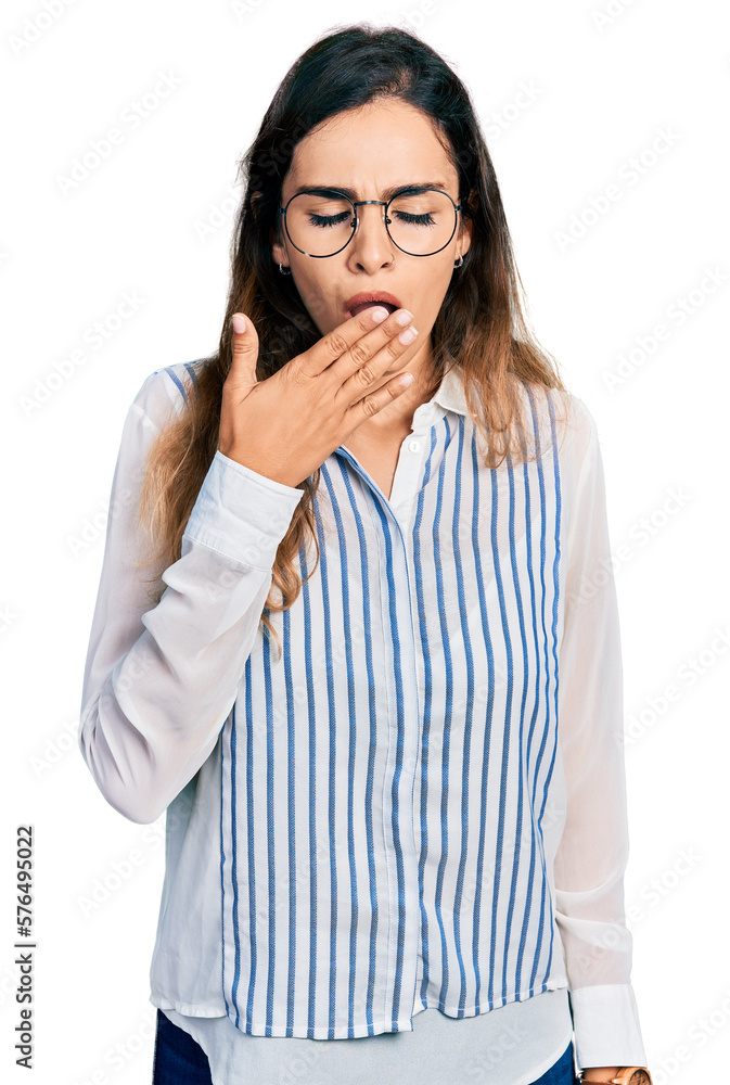 Beautiful hispanic woman wearing casual striped shirt bored yawning tired covering mouth with hand. restless and sleepiness. Beautiful hispanic woman wearing casual striped shirt bored yawning tired covering mouth with hand. restless and sleepiness.