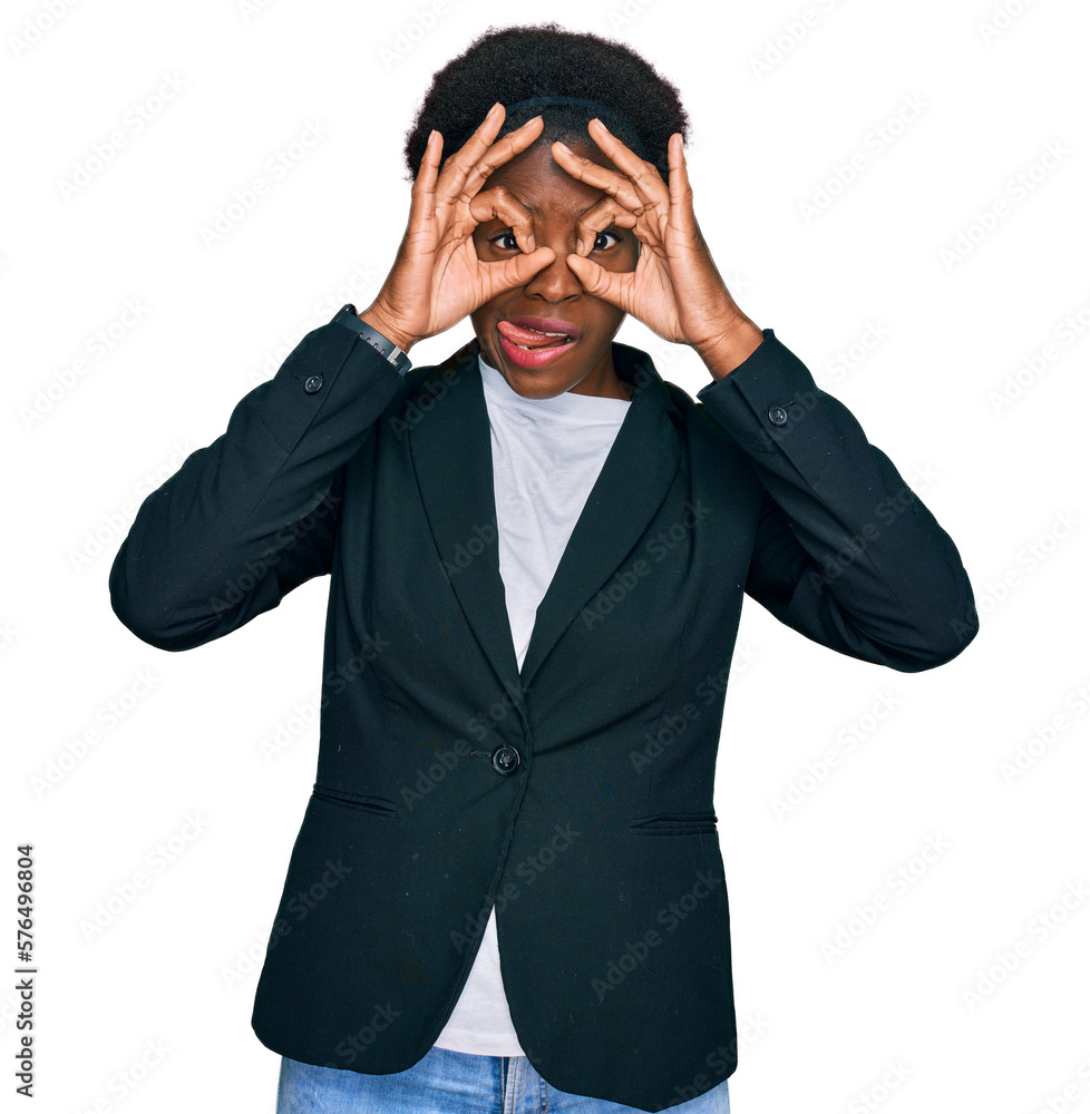 Young african american girl wearing business clothes doing ok gesture like binoculars sticking tongue out, eyes looking through fingers. crazy expression. Young african american girl wearing business clothes doing ok gesture like binoculars sticking tongue out, eyes looking through fingers. crazy expression.