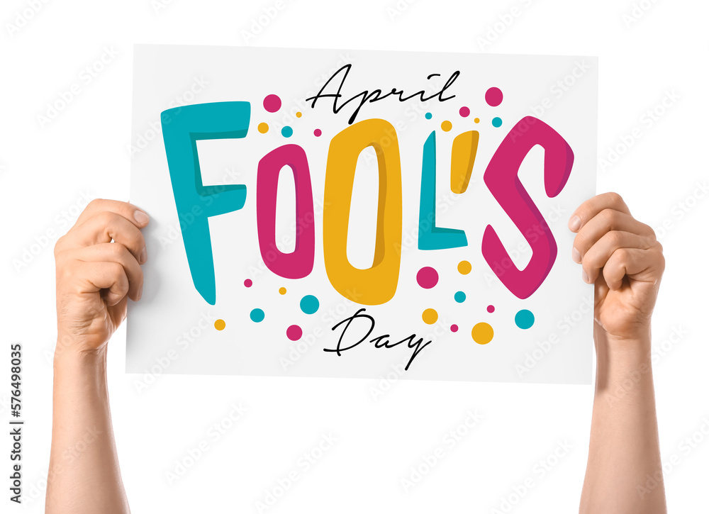 Fototapeta premium Hands holding poster with text APRIL FOOLS DAY on white background