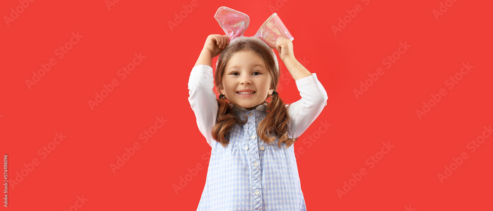 Little girl with Easter bunny ears on red background Little girl with Easter bunny ears on red background