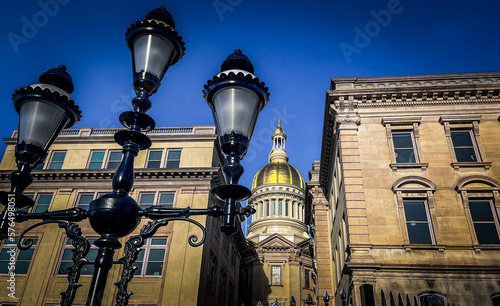 View of the New Jersey statehouse with golden dome with historic lamp post in the foreground in Trenton photo