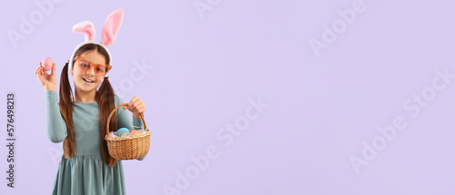 Funny girl with bunny ears and Easter basket on lilac background with space for text
