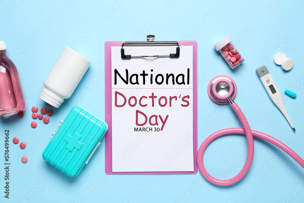 Clipboard with text NATIONAL DOCTORS DAY, stethoscope and drugs on light blue background