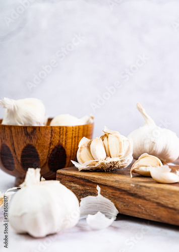 Garlic on a wooden board, white background, text space