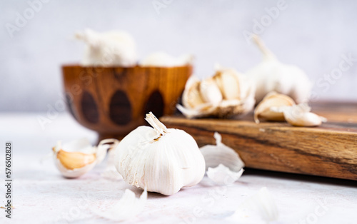 garlic bulb and garlic clove on wooden board