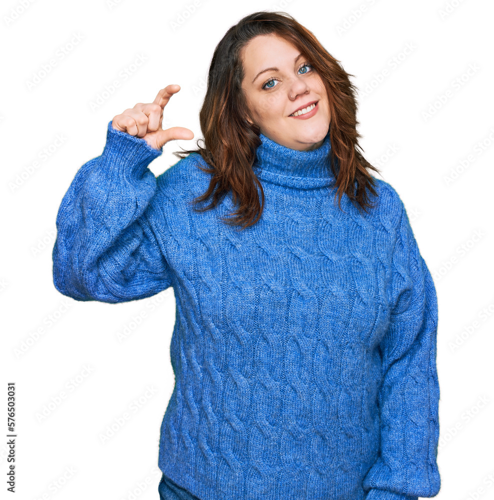 Young plus size woman wearing casual clothes smiling and confident gesturing with hand doing small size sign with fingers looking and the camera. measure concept.
