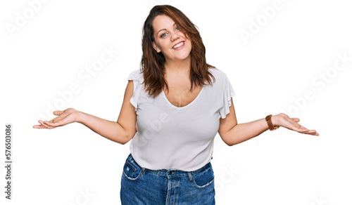 Young plus size woman wearing casual white t shirt smiling showing both hands open palms, presenting and advertising comparison and balance