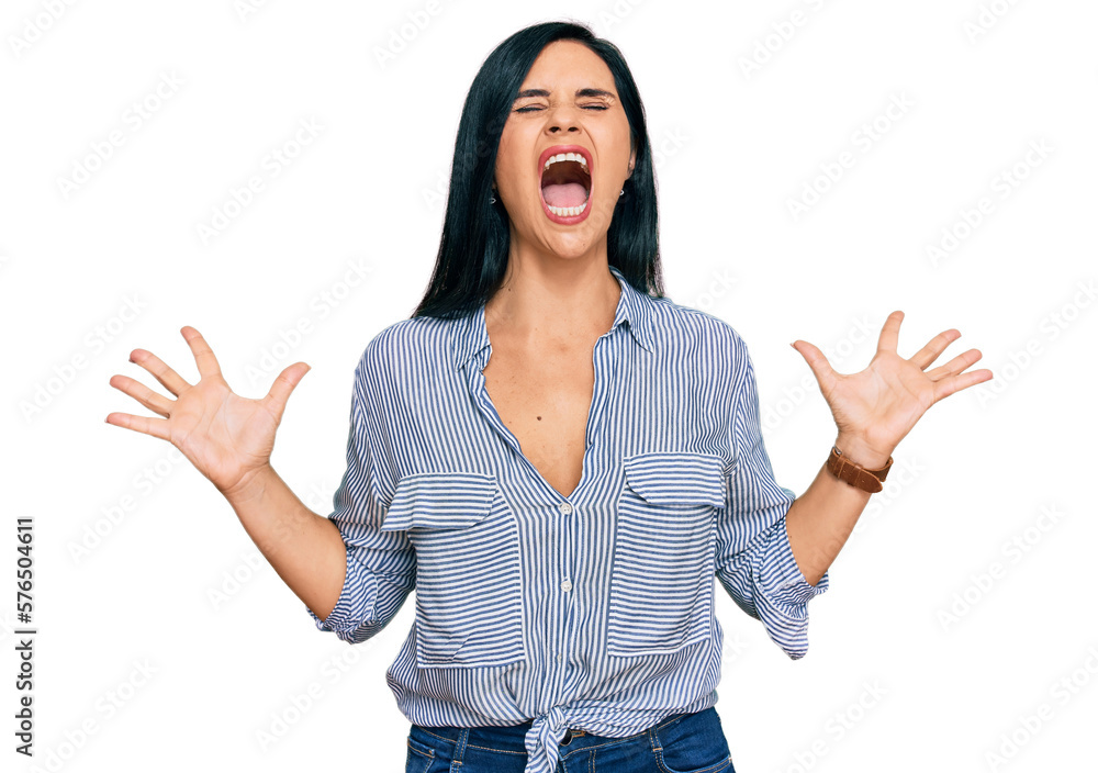 Young caucasian woman wearing casual clothes crazy and mad shouting and yelling with aggressive expression and arms raised. frustration concept. Young caucasian woman wearing casual clothes crazy and mad shouting and yelling with aggressive expression and arms raised. frustration concept.
