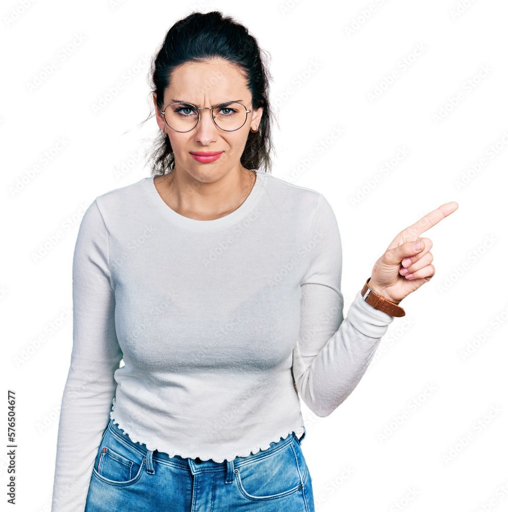 Young hispanic woman pointing with fingers to the side clueless and confused expression. doubt concept. Young hispanic woman pointing with fingers to the side clueless and confused expression. doubt concept.