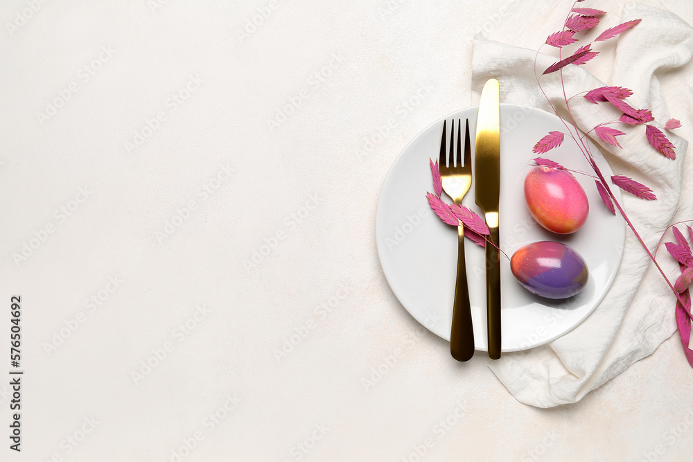 Table setting with Easter eggs, cutlery and plant branch on white background Table setting with Easter eggs, cutlery and plant branch on white background