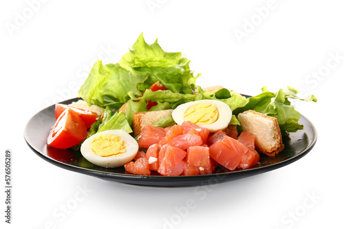 Plate of delicious salad with boiled eggs and salmon isolated on white background