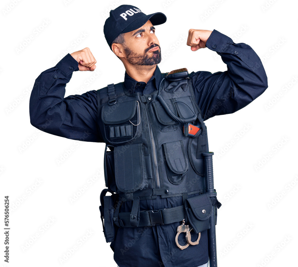 Young hispanic man wearing police uniform showing arms muscles smiling proud. fitness concept. Young hispanic man wearing police uniform showing arms muscles smiling proud. fitness concept.
